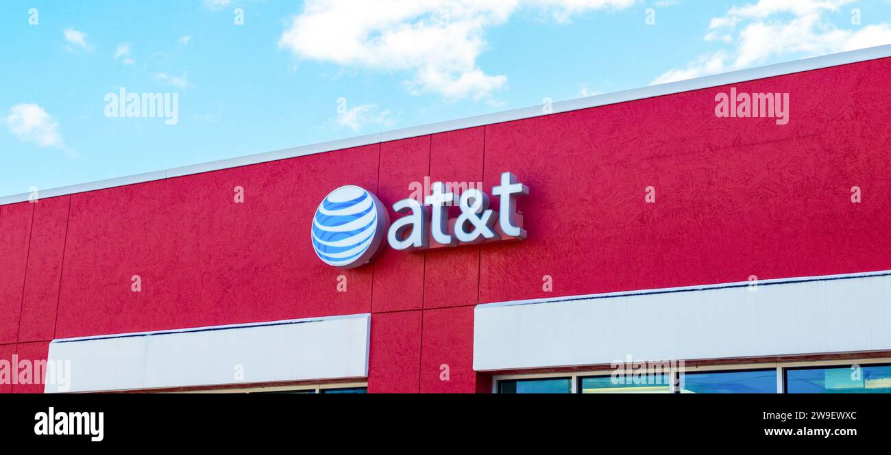 Exterior retail store front logo ATT American multinational telecommunications OCALA, FLORIDA USA, OCTOBER 14, 2023 in strip mall. Owner of HBO, CNN a Stock Photo