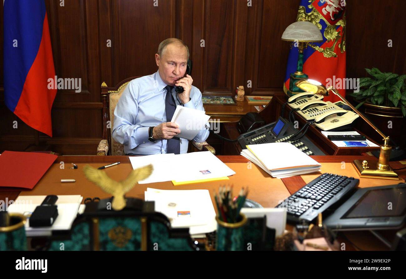 Moscow, Russia. 27th Dec, 2023. Russian President Vladimir Putin speaks by phone with Nikita Miroshnichenko, an 11-year-old boy from Kostroma region, who took part in the New Year Tree of Wishes charity campaign from the Kremlin, December 27, 2023 in Moscow, Russia. Miroshnichenko wished to tour the Hermitage Museum and landmarks of St Petersburg. Credit: Gavriil Grigorov/Kremlin Pool/Alamy Live News Stock Photo