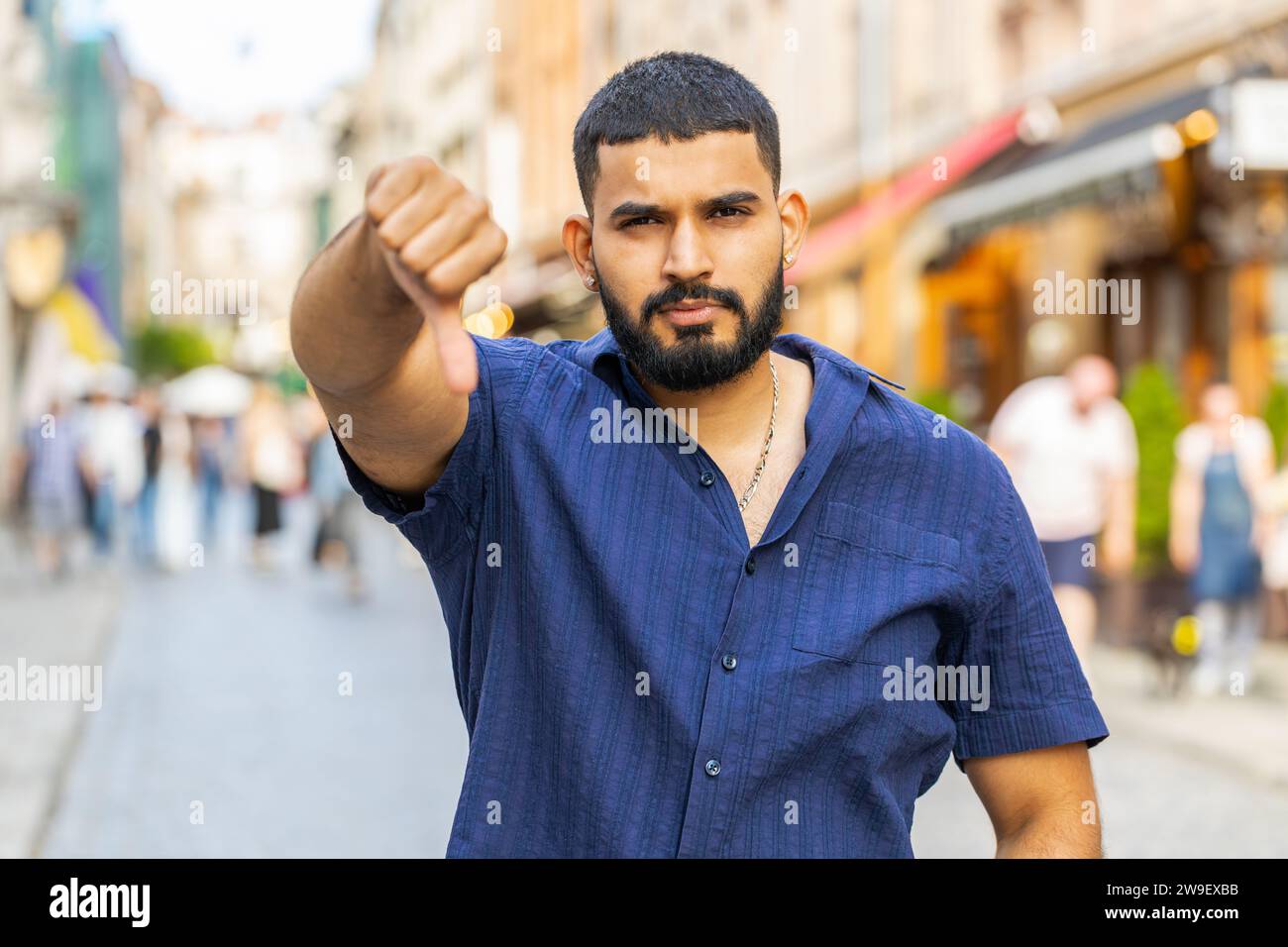 Dislike. Upset bearded indian man showing thumbs down sign gesture ...