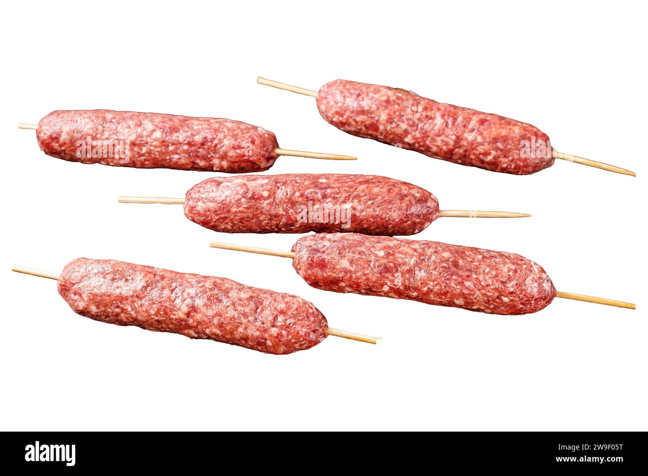 Raw kofta meat kebabs sausages on skewers. Isolated on white background