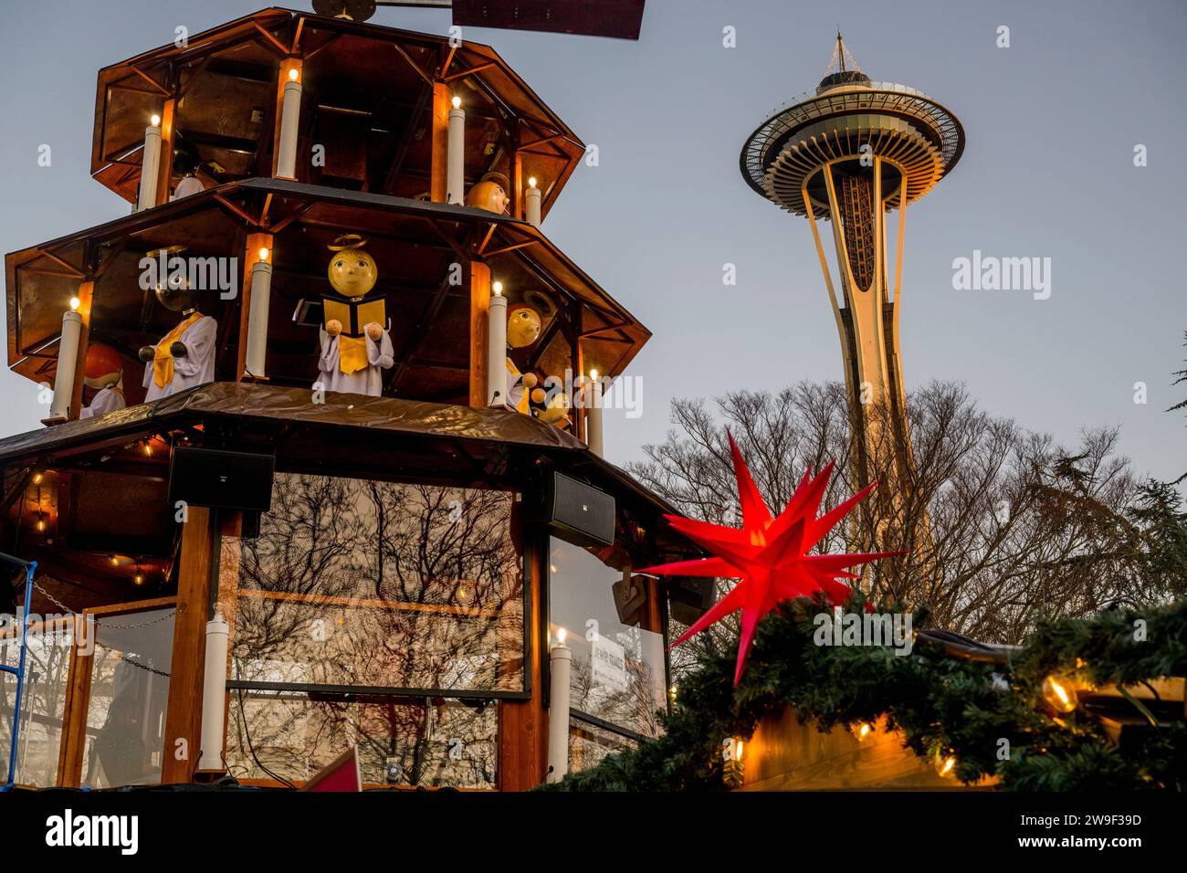 Seattle Christmas Market scene with holiday lights, Christmas Pyramid, and the Space Needle at