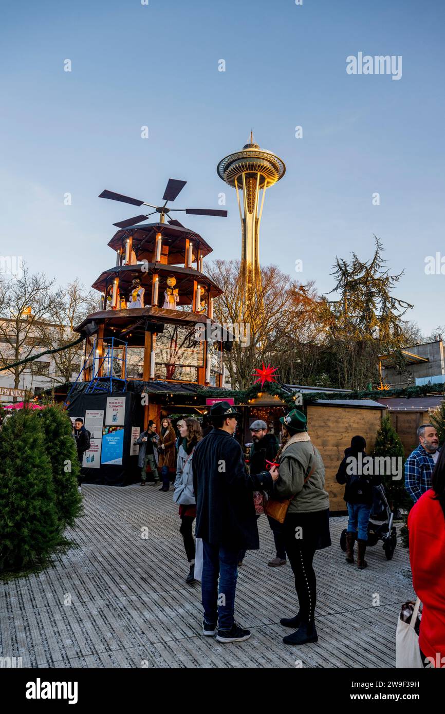 Seattle Christmas Market scene with holiday lights, Christmas Pyramid, and the Space Needle at