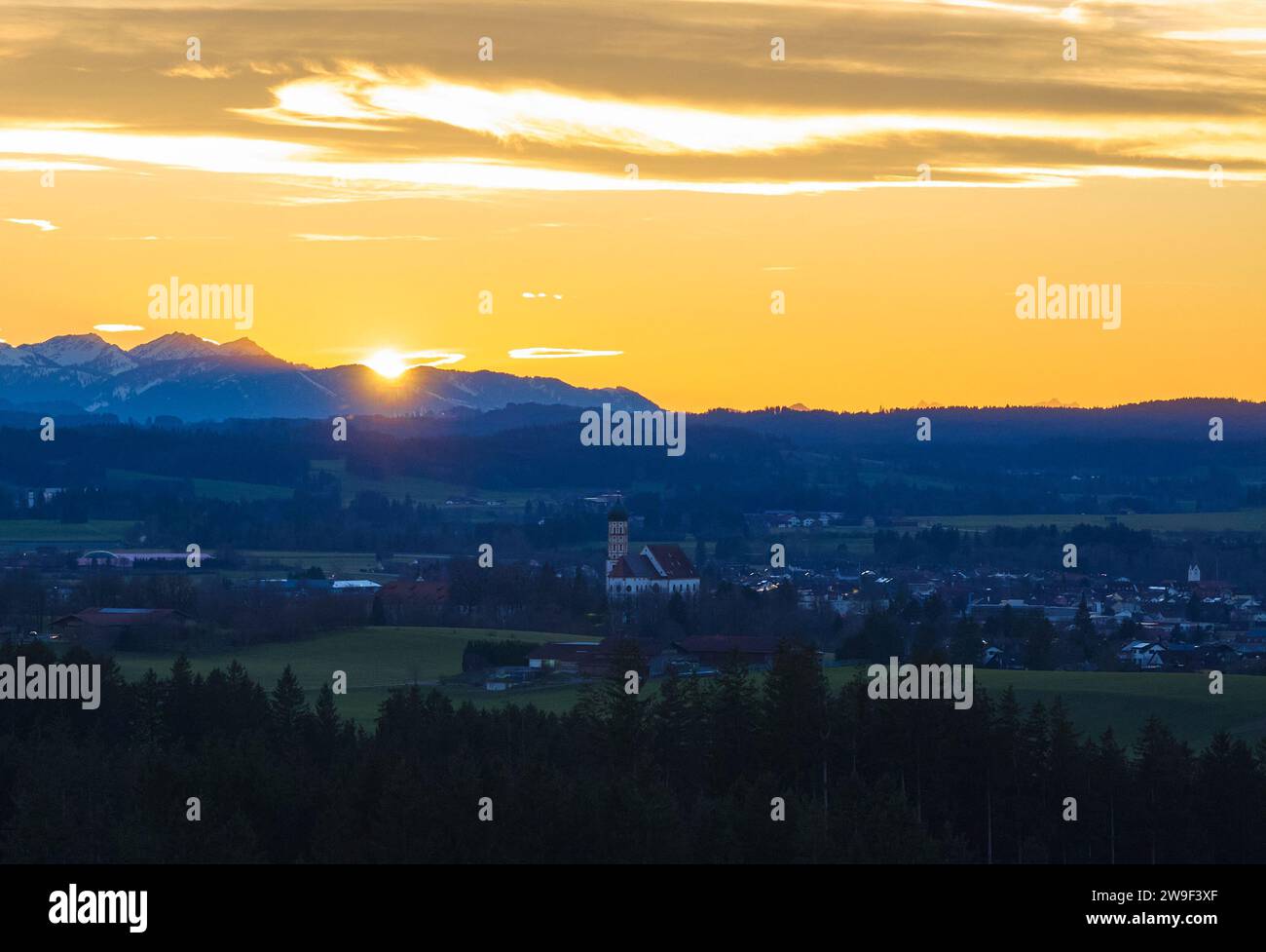 Bavarian landscape with city view, St.Martin church  in the evening, short before sunset in Marktoberdorf, Germany, Dec 25, 2023.  © Peter Schatz / Alamy Stock Photos Stock Photo