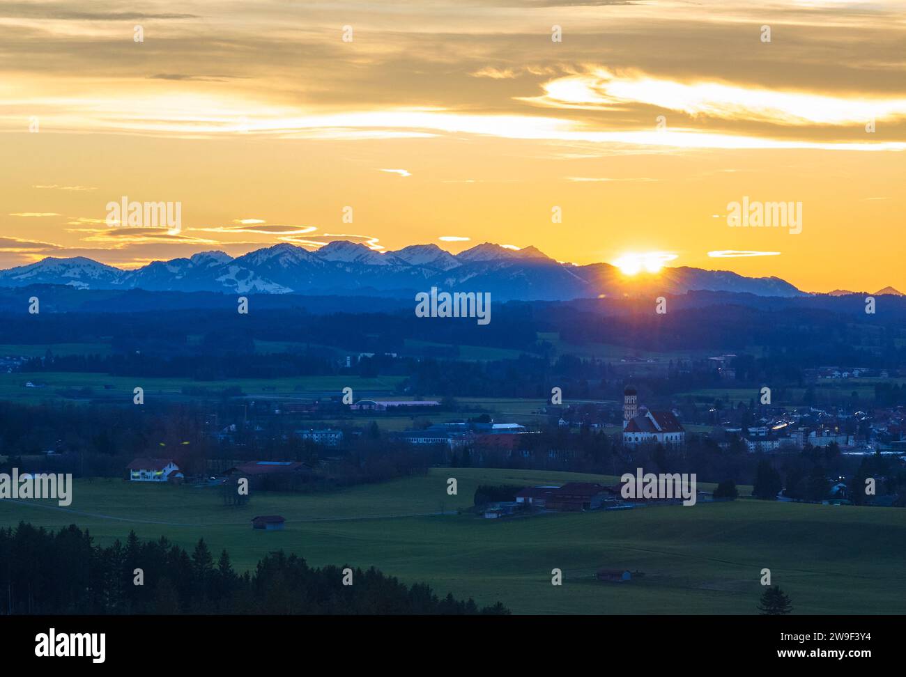 Bavarian landscape with city view, St.Martin church  in the evening, short before sunset in Marktoberdorf, Germany, Dec 25, 2023.  © Peter Schatz / Alamy Stock Photos Stock Photo