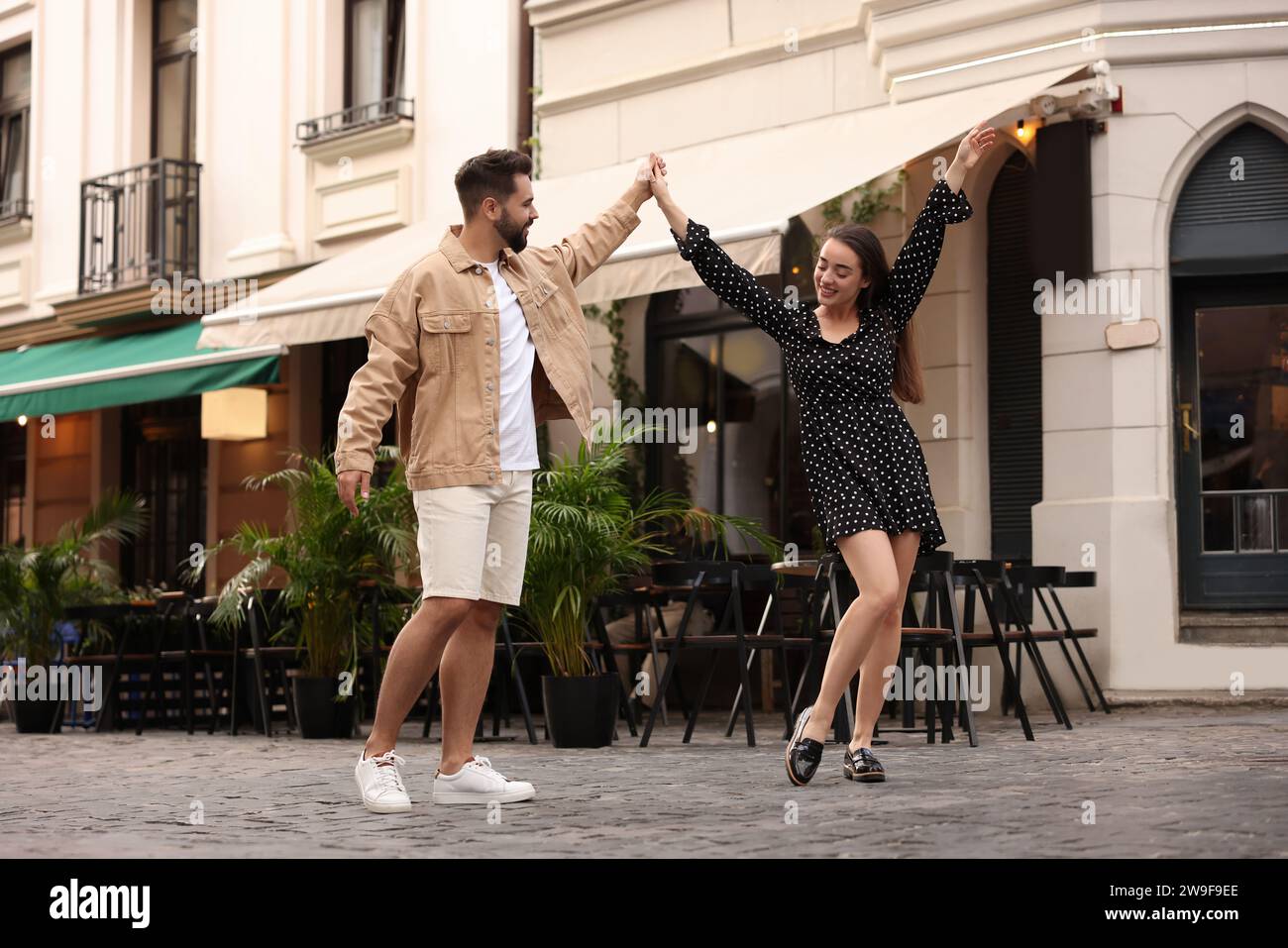 Lovely couple dancing together on city street Stock Photo - Alamy