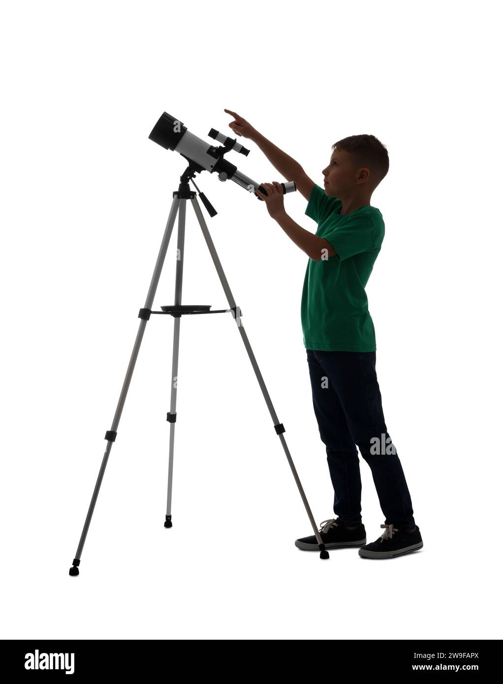 Cute little boy with telescope pointing at something on white background Stock Photo