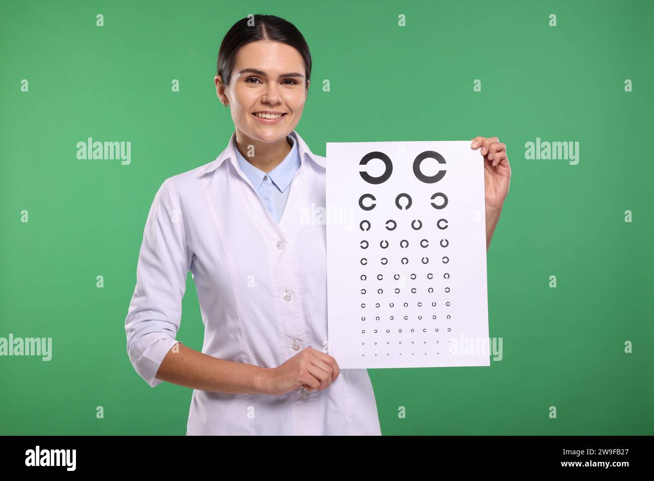 Vision Test Background Ophthalmologist with vision test chart on green background Stock Photo ...