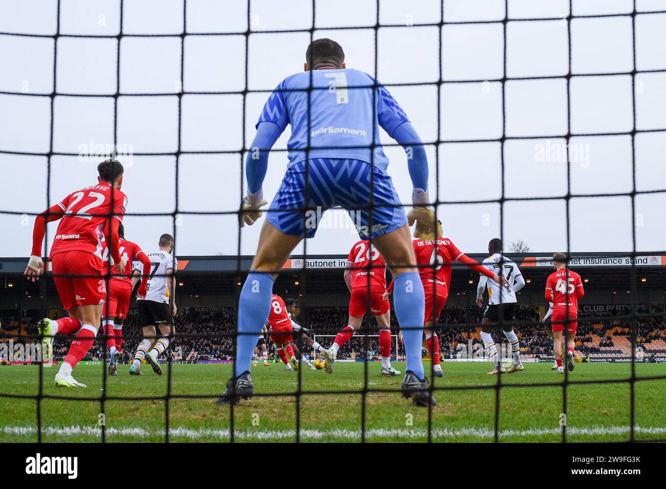Burslem, UK, 26th December 2023. Port Vale's number 24, Rhys Walters, takes aim at the Barnsley Keeper Liam Roberts through a crowded penalty box during Vale's EFL League One Boxing Day home tie. Credit: TeeGeePix/Alamy Live News Stock Photo