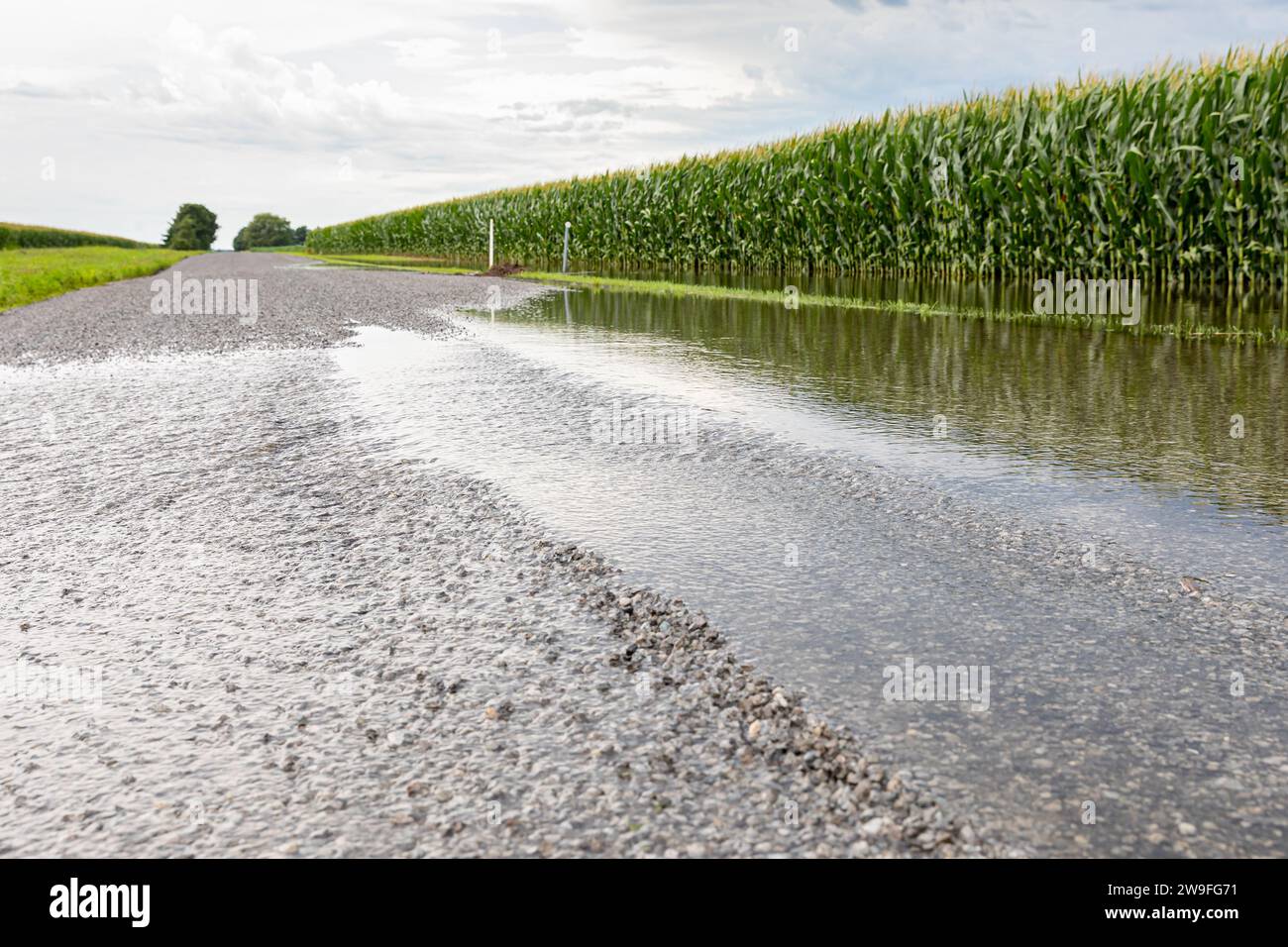 Rural road flooding from heavy rainstorm. Storm and rain damage, weather warning and climate change concept. Stock Photo