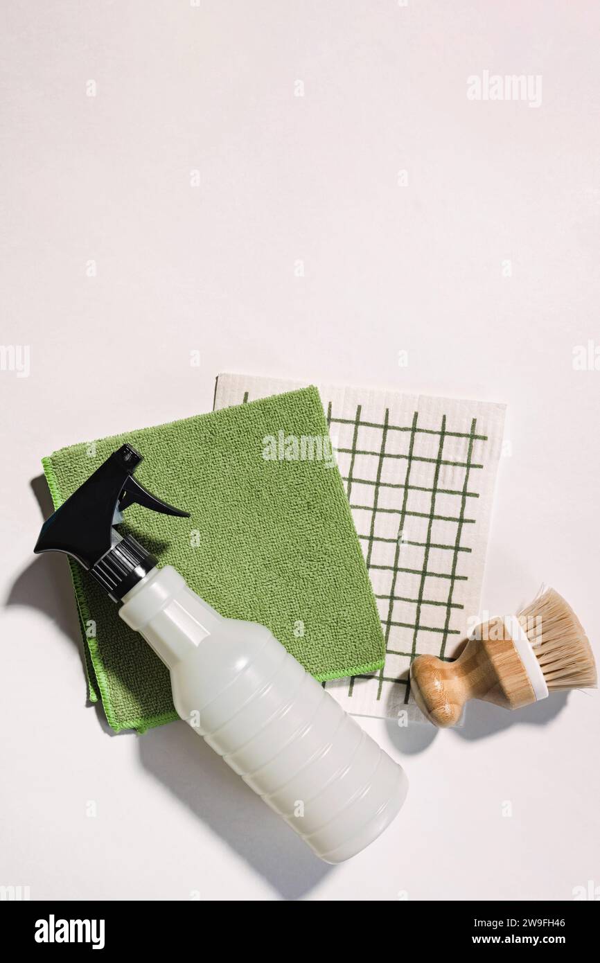 Cleaning supplies on white background, spray, brush and dishcloth, eco