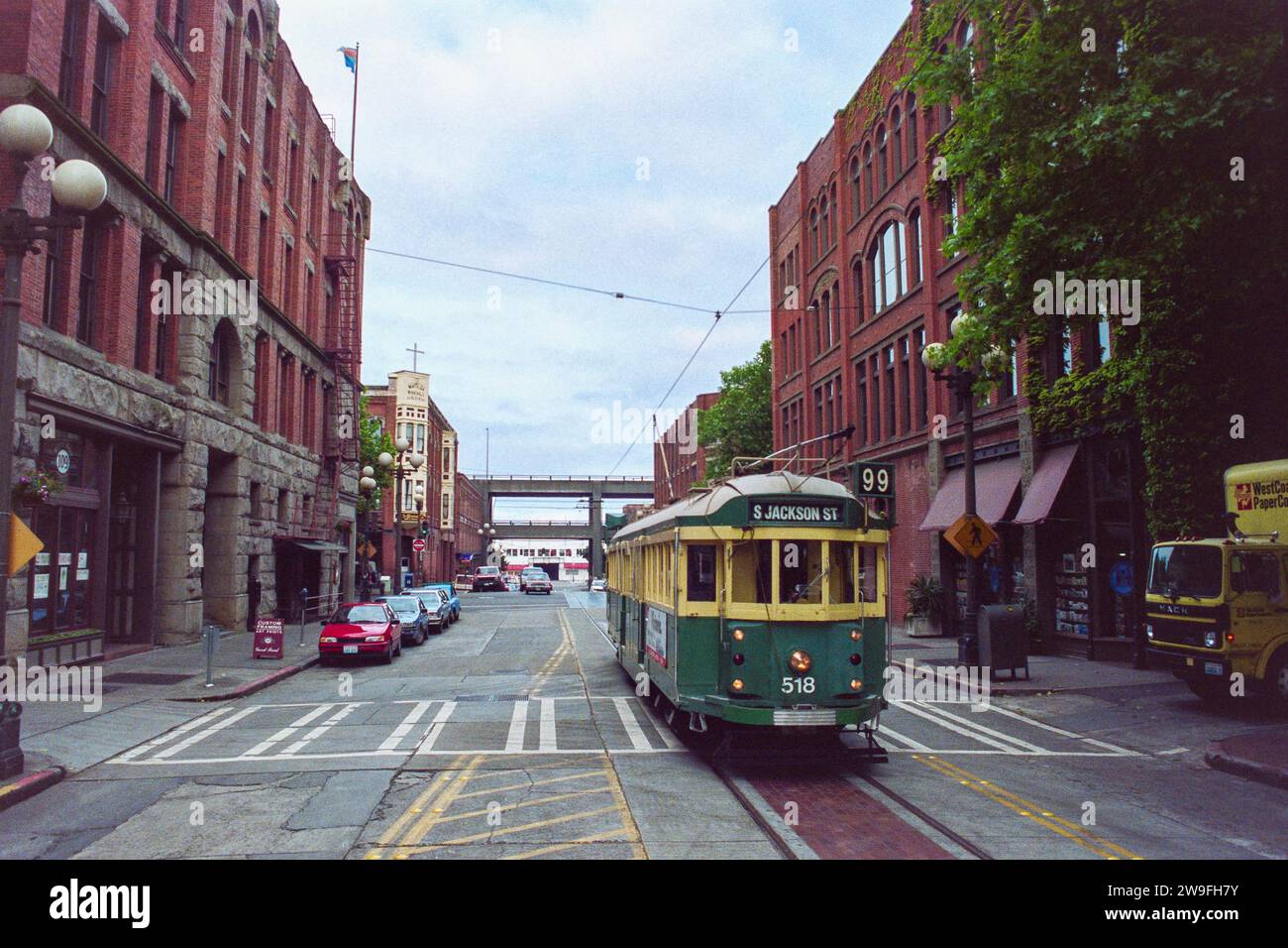 Seattle, Washington, USA - May 9, 1992:  Grainy archival film photograph of the S Jackson Street trolley on the 100 block of South Main Street.  The bridges in background have been demolished. Stock Photo