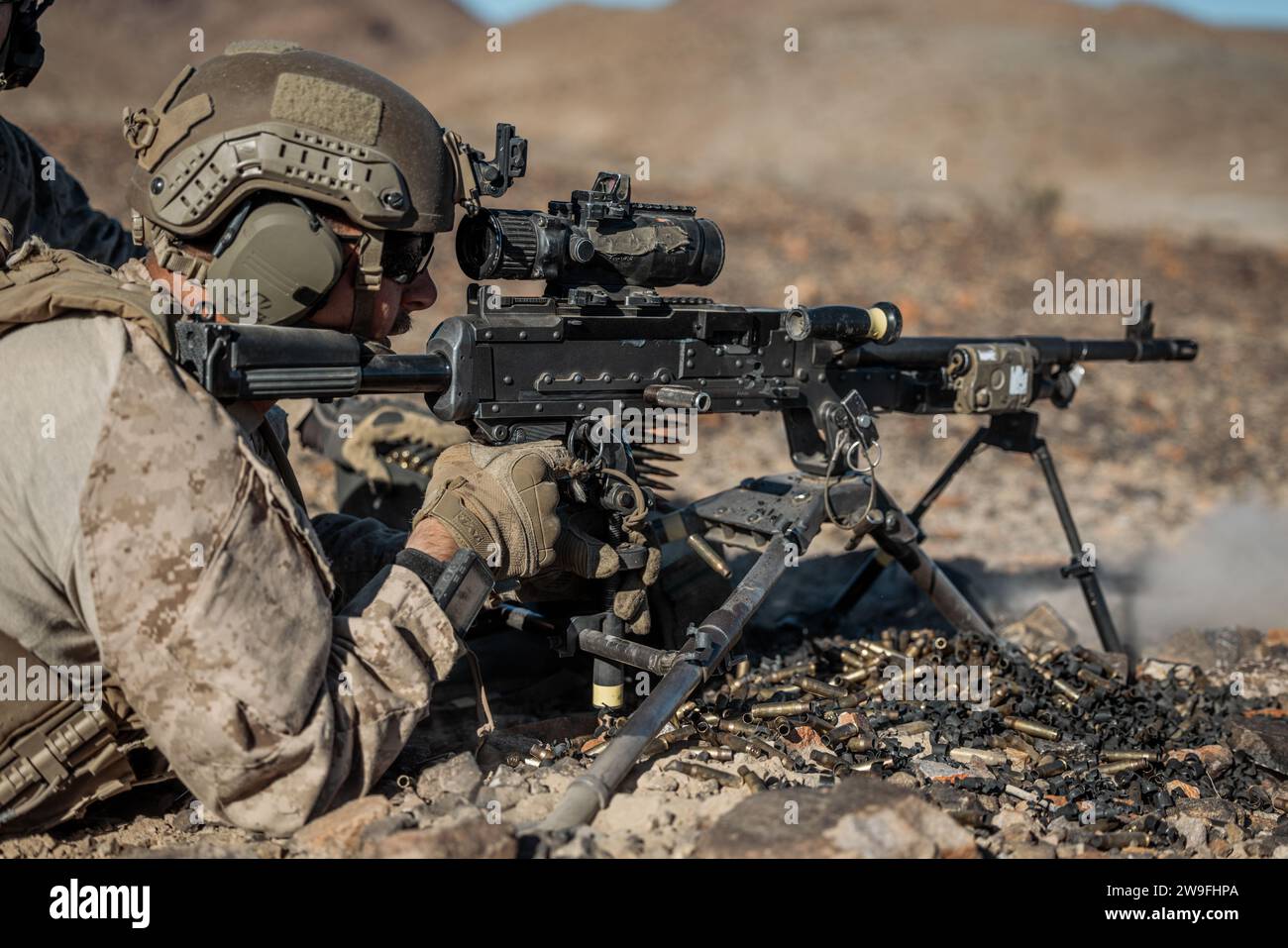 A U.S Marine with 3rd Battalion, 4th Marine Regiment (REIN), 7th Marine Regiment, 1st Marine Division fires an M240B machine gun at Range 401 during Exercise Steel Knight 23.2 at Marine Corps Air-Ground Combat Center, Twentynine Palms, California, Dec. 12, 2023.  Steel Knight is a three-phase exercise designed to train I Marine Expeditionary Force in the planning, deployment and command and control of a joint force against a peer or near-peer adversary combat force and enhance existing live-fire and maneuver capabilities of the Marine Air Ground Task Force. (U.S. Marine Corps Photo by Lance Cp Stock Photo