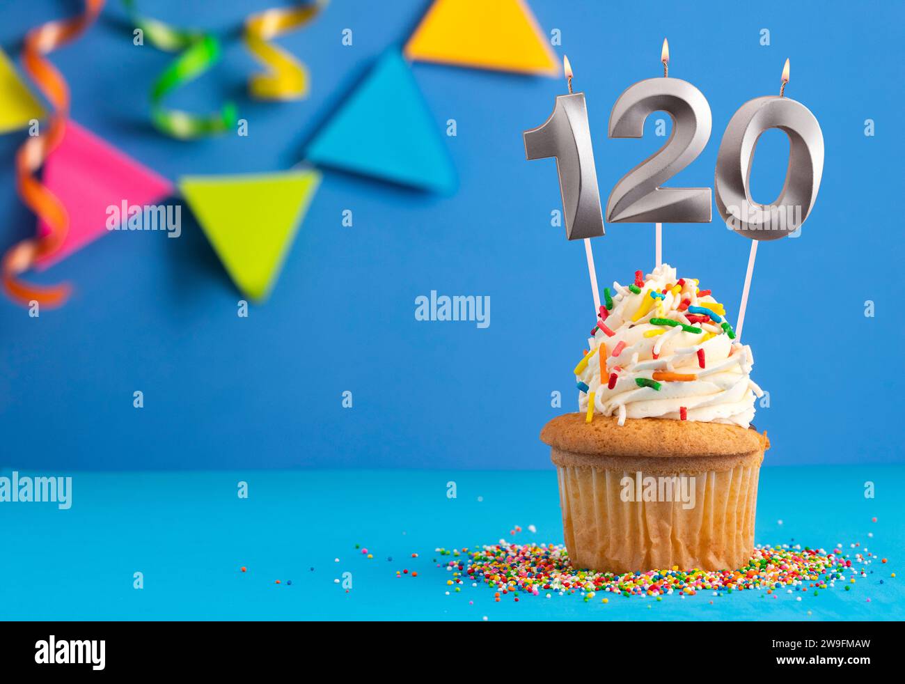 Birthday cake with candle number 120 - Blue background Stock Photo - Alamy