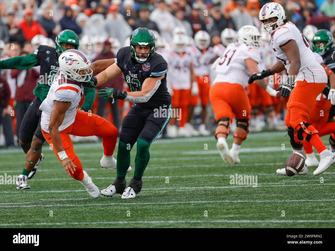 Annapolis, MD, USA. 27th Dec, 2023. Tulane Green Wave LB #13 Tyler Grubbs watches a fumbled football during the Go Bowling Military Bowl between the Tulane Green Wave and the Virginia Tech Hokies at Navy-Marine Corp Memorial Stadium in Annapolis, MD. Justin Cooper/CSM/Alamy Live News Stock Photo