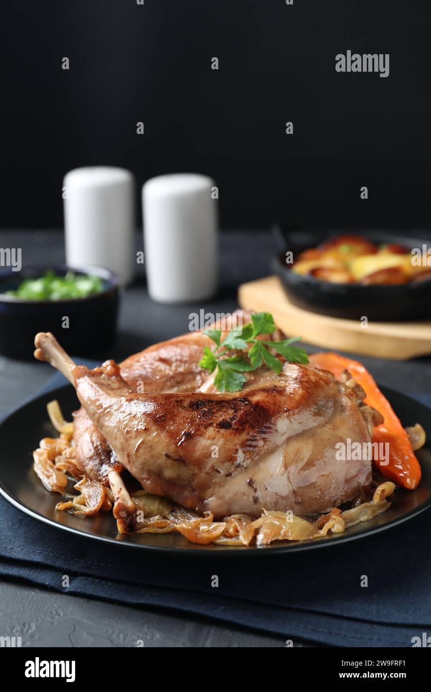 Tasty cooked rabbit meat with vegetables served on table Stock Photo