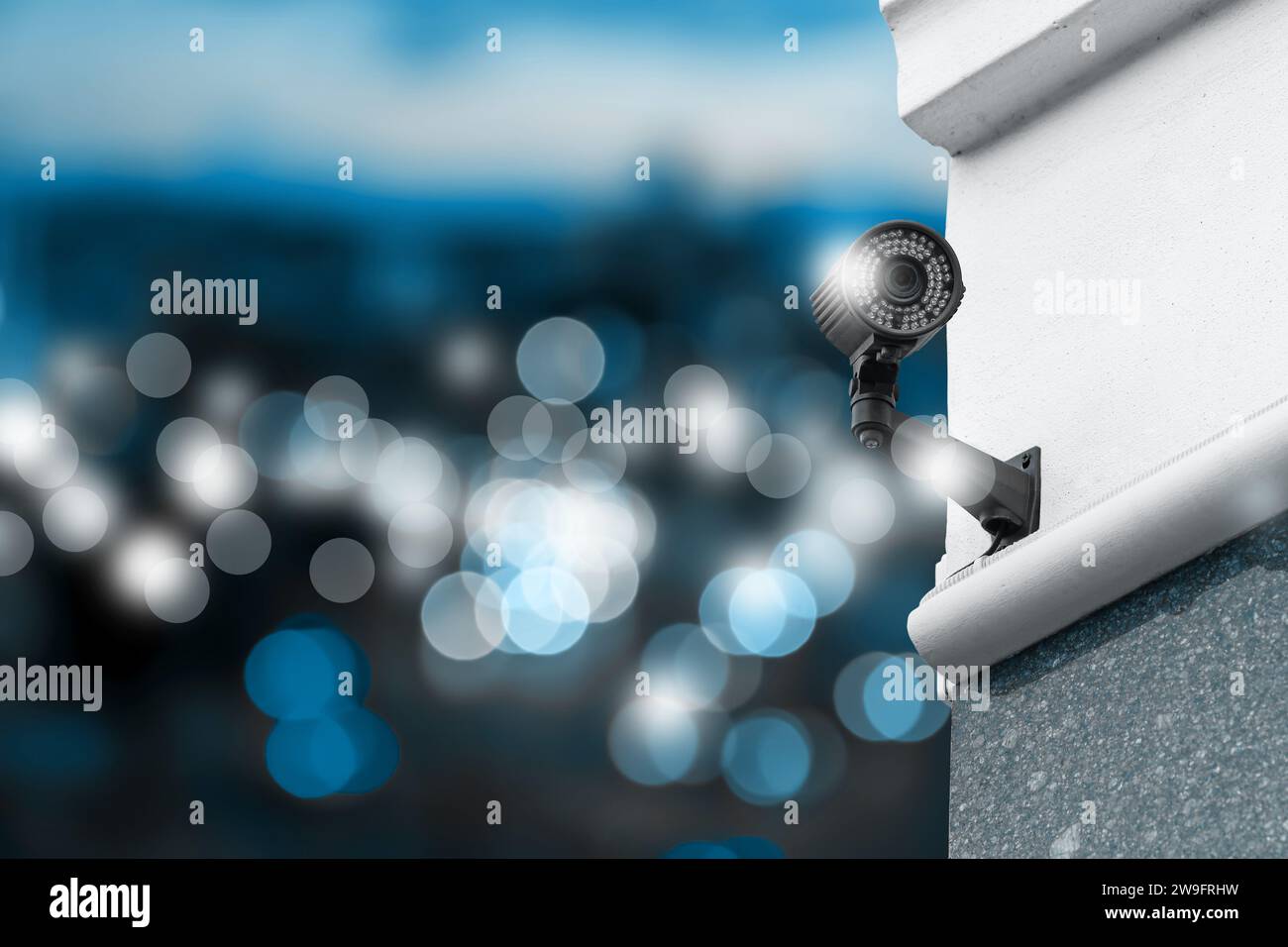 Modern security CCTV camera on building wall outdoors, space for text Stock Photo