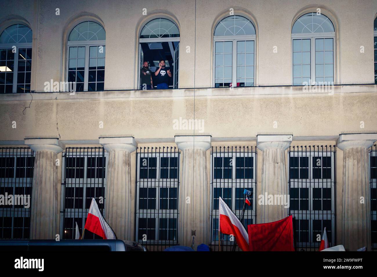 PiS propagandists in the window of occupied TVP INFO. After losing the elections, Law and Justice is postponing the return of the public media, which they used as a propaganda outlet. Warsaw Poland Copyright: xMikolajxJaneczekx Stock Photo