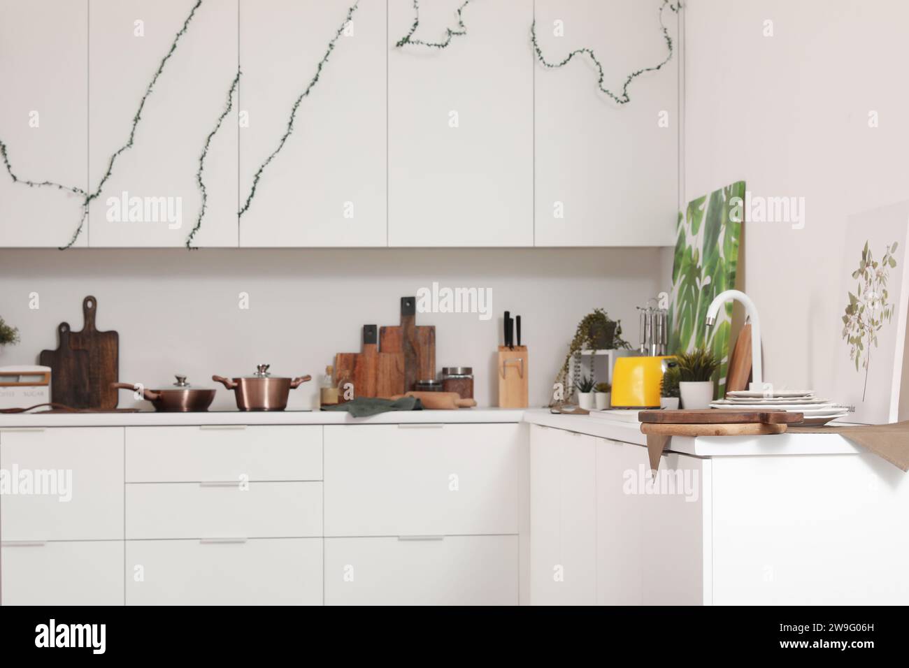 Interior of modern kitchen with white counters and utensils Stock Photo ...