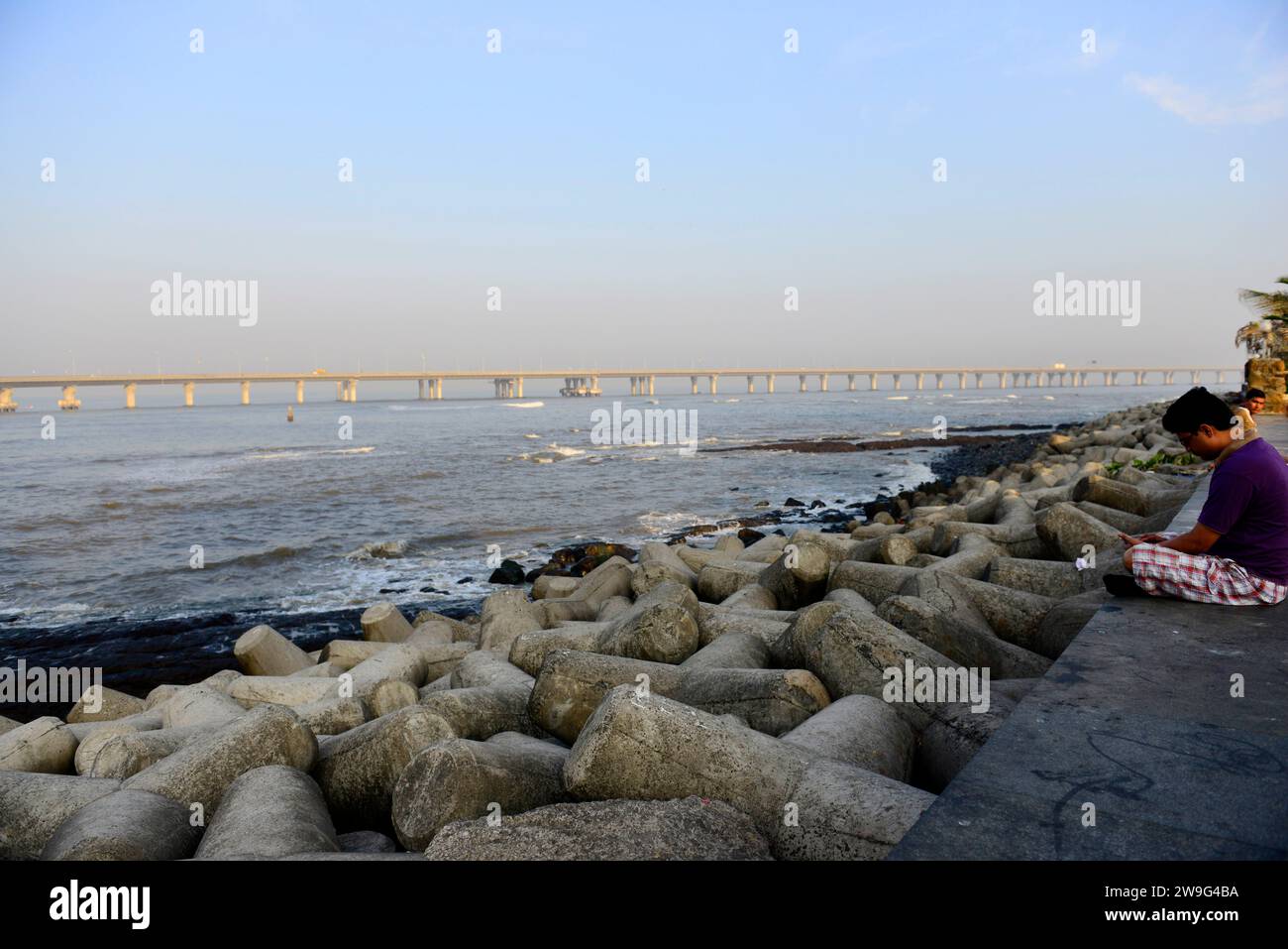 Alone by the Arabian Sea at the modern seafront promenade in Worli, Mumbai, India. Stock Photo