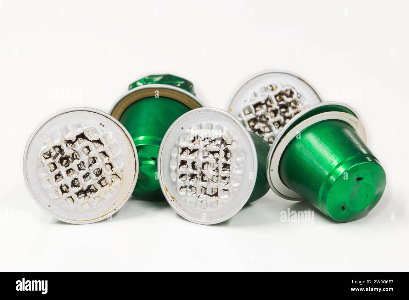 Green used plastic Espresso coffee pods single use cups, isolated on a