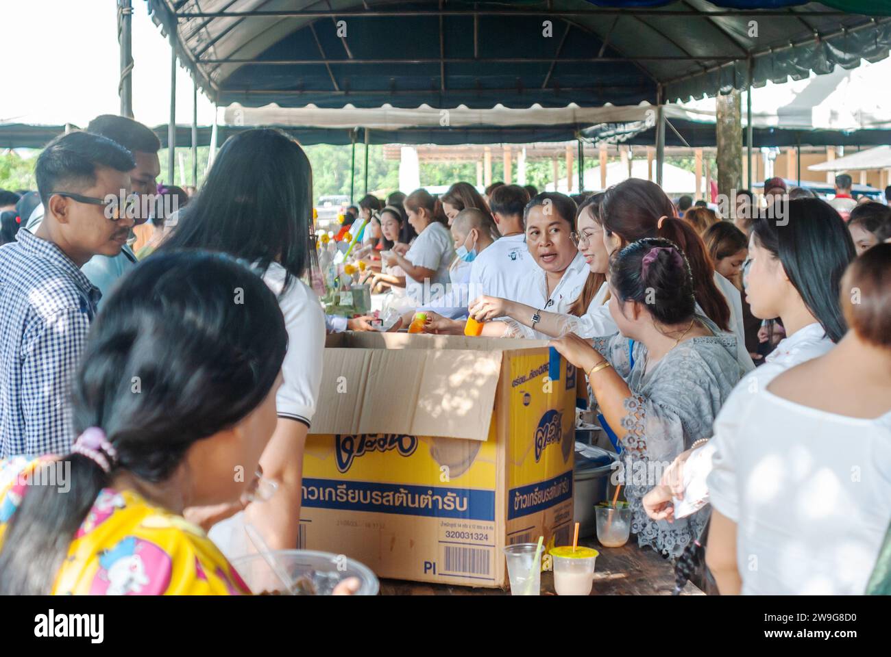 SURATTANI, THAILAND- NOV. 06, 2023: People waiting to receive food distribution to people coming to the Kathin merit-making festival in Thailand Stock Photo