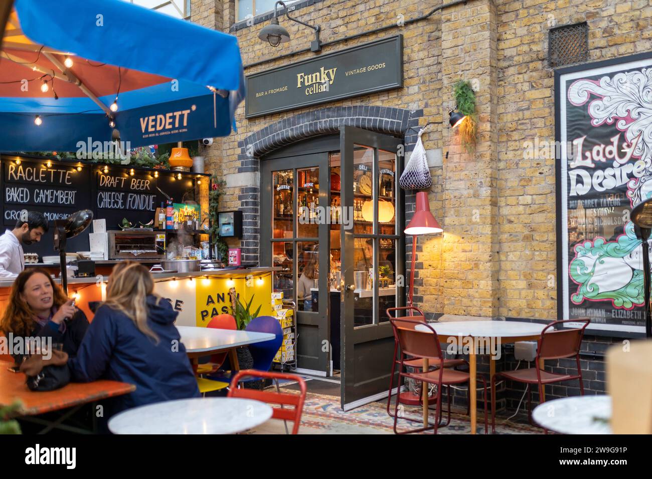 LONDON UK -JUNE 27 2023: Funky cellar cafe at Spitalfields Market. Inner courtyard for visitors. Stock Photo