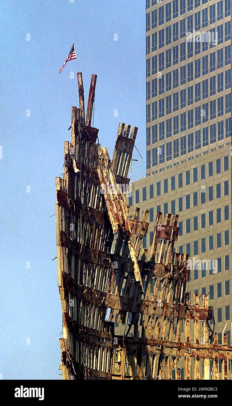 File photo dated 23/9/2001 of a US flag flies from the remains of the World Trade Centre. Civil servants were warned that the allocation of EU funds to ex-prisoner groups in Northern Ireland was to come under intensified scrutiny from Brussels in the wake of 9/11. Officials were told of inevitably heightened sensitivities within the European Commission on how its Peace Programme funding initiative would be portrayed internationally, after the terror attack on the US, according to a newly released archive document from the Public Records Office of Northern Ireland. Issue date: Thursday December Stock Photo