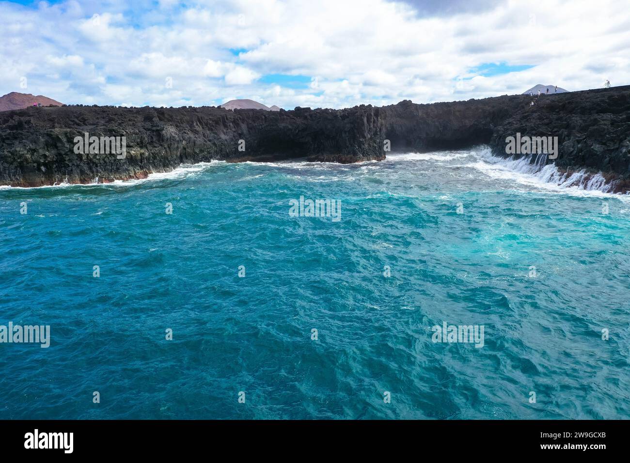 Aerial panorama view of Los Hervideros. Southwest coast, rugged volcanic coast, strong surf, sea caves, red lava hills. Lanzarote, Canary Islands, Spa Stock Photo