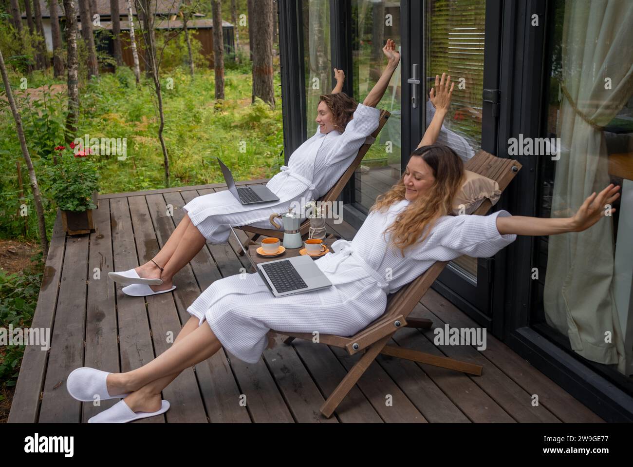 Women on sunbeds outside stretch. Vacationing relaxing resting girls