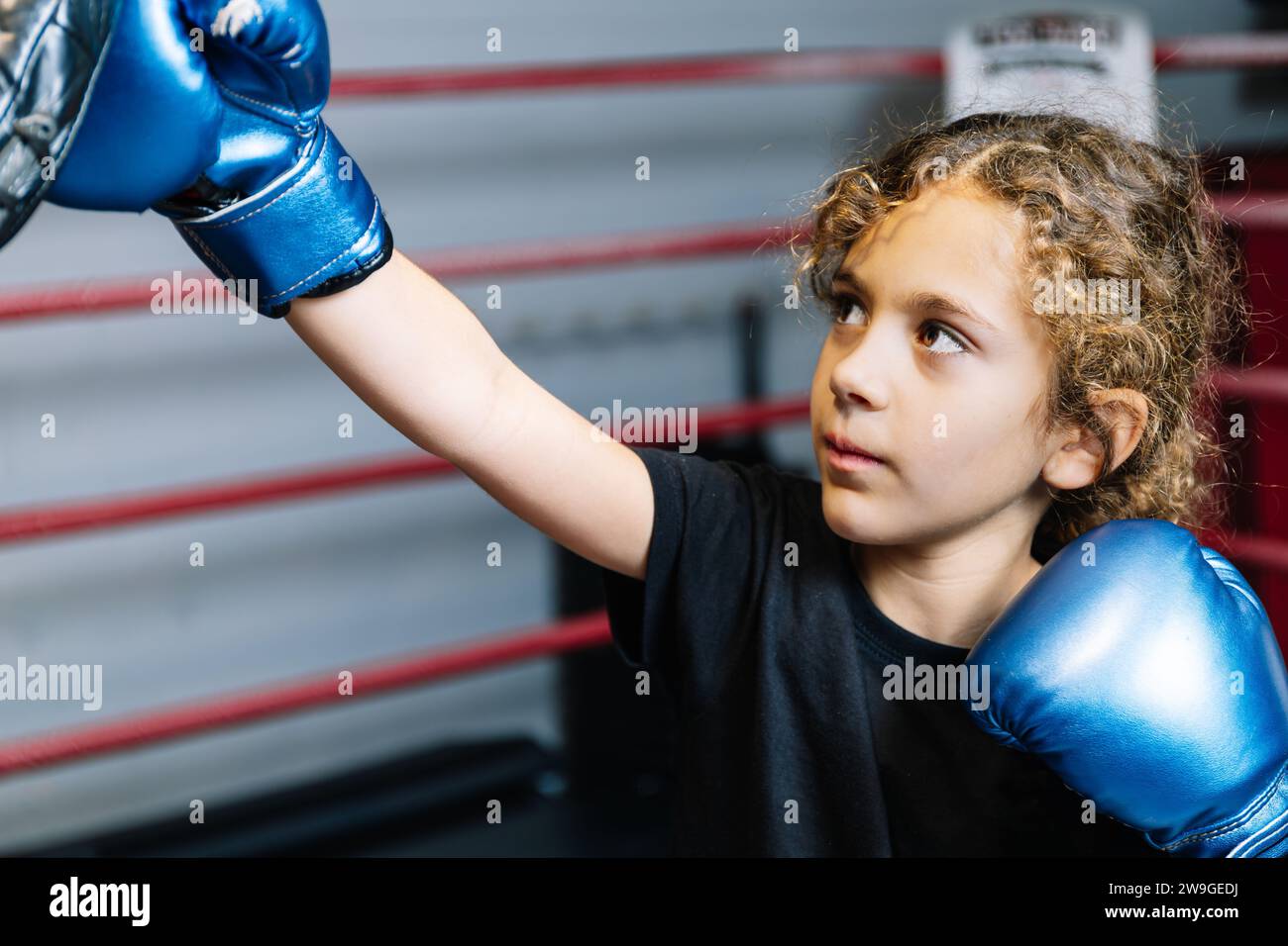 Horizontal photo elementary girl, dressed in black tshirt and blue