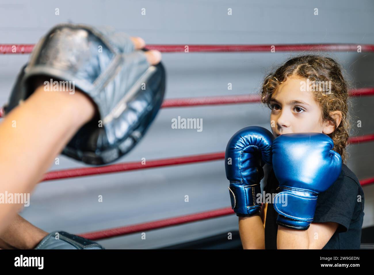 Horizontal photo elementary girl, dressed in black tshirt and blue