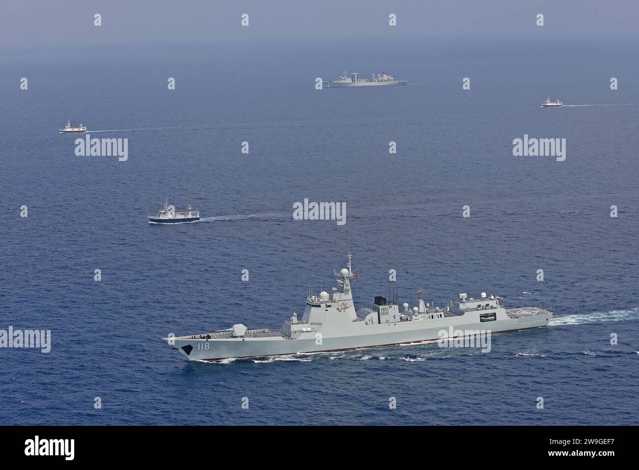 (231228) -- BEIJING, Dec. 28, 2023 (Xinhua) -- The guided-missile destroyer Urumqi (front) and the comprehensive replenishment vessel Dongpinghu (back) of the 45th escort mission fleet dispatched by the Chinese People's Liberation Army (PLA) Navy escort Chinese fishing boats on Oct. 20, 2023. Since December 2008, China has been dispatching naval ships to carry out vessel protection operations in the Gulf of Aden and the waters off Somalia. Over the past 15 years, 45 consecutive fleets, 150 vessels and 35,000 personnel of the PLA Navy have joined the efforts, escorting more than 7,200 Chinese Stock Photo