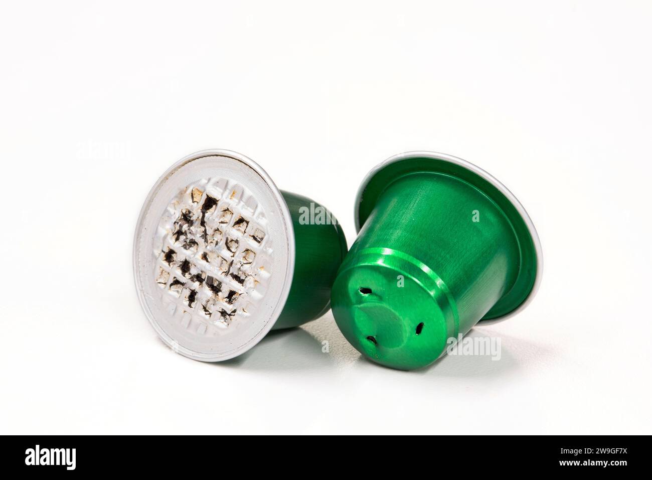 Green used plastic Espresso coffee pods single use cups, isolated on a white background with copy space. Stock Photo