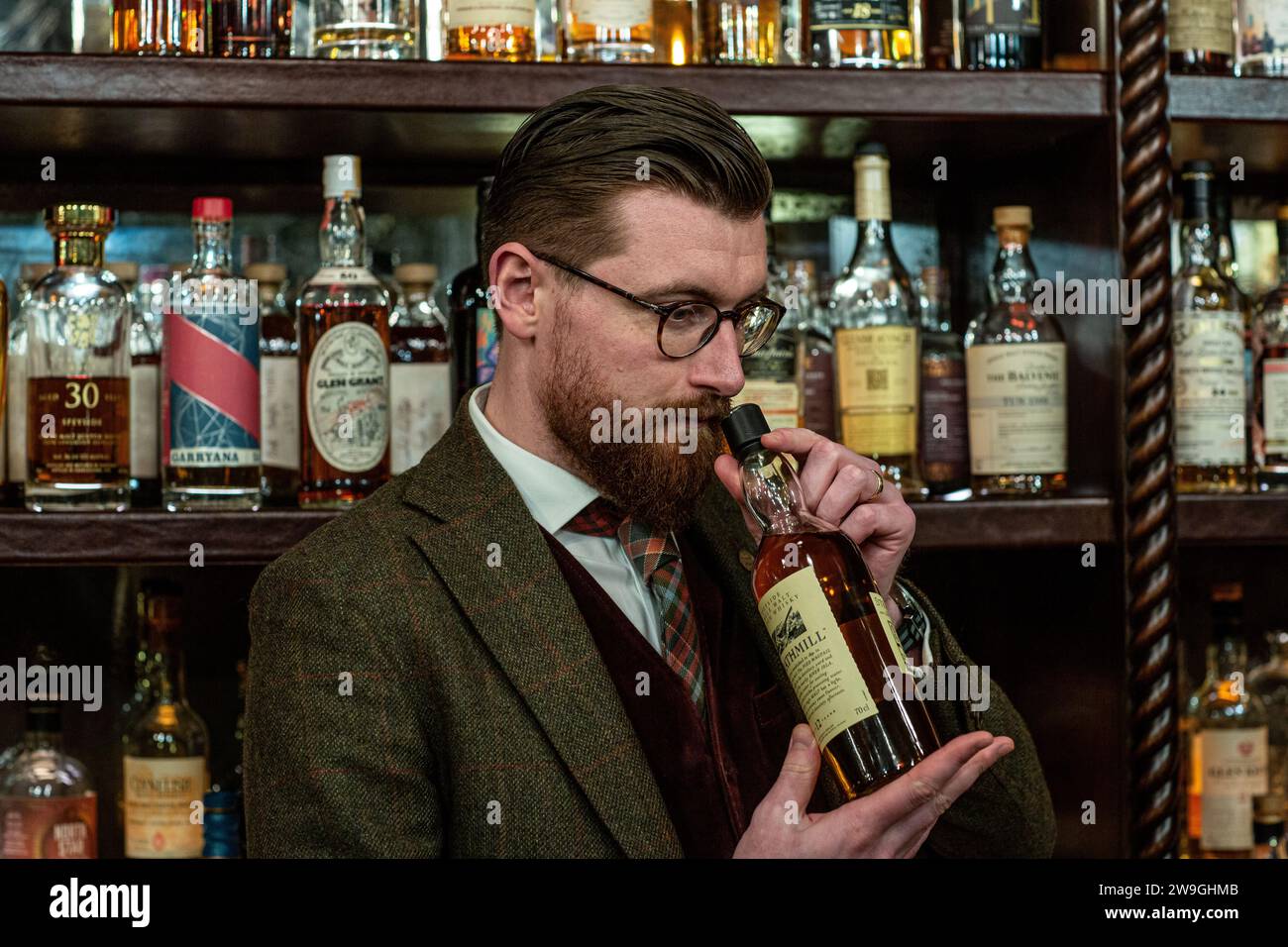 Mark Shedden -  Bertie's Whisky Manager nosing whisky. ,Bertie's Whisky Bar, Fife Arms, Braemar,Scotland. Stock Photo