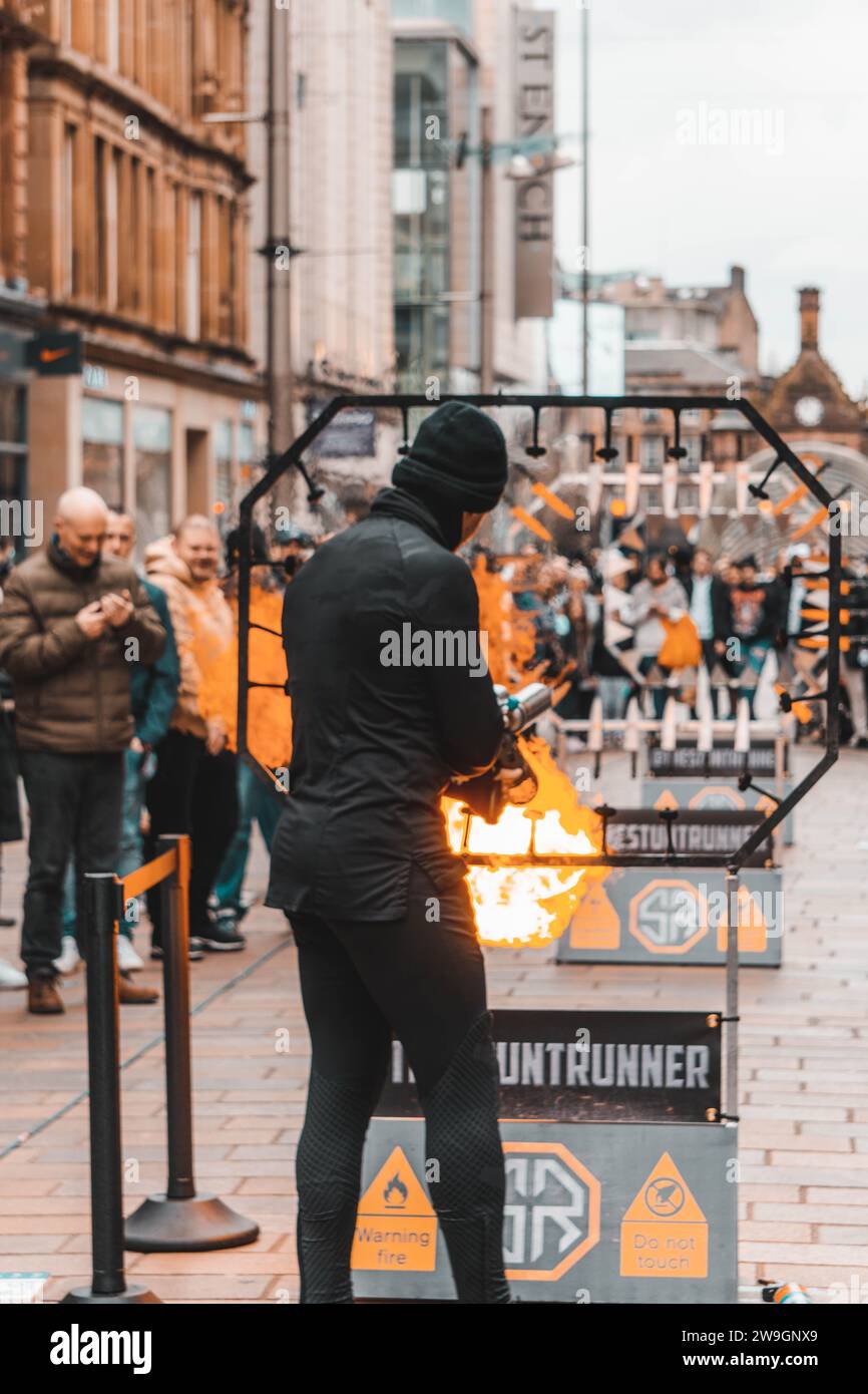 Street Performer Jumps Through Fire Glasgow Scotland Buchannan Street Stock Photo
