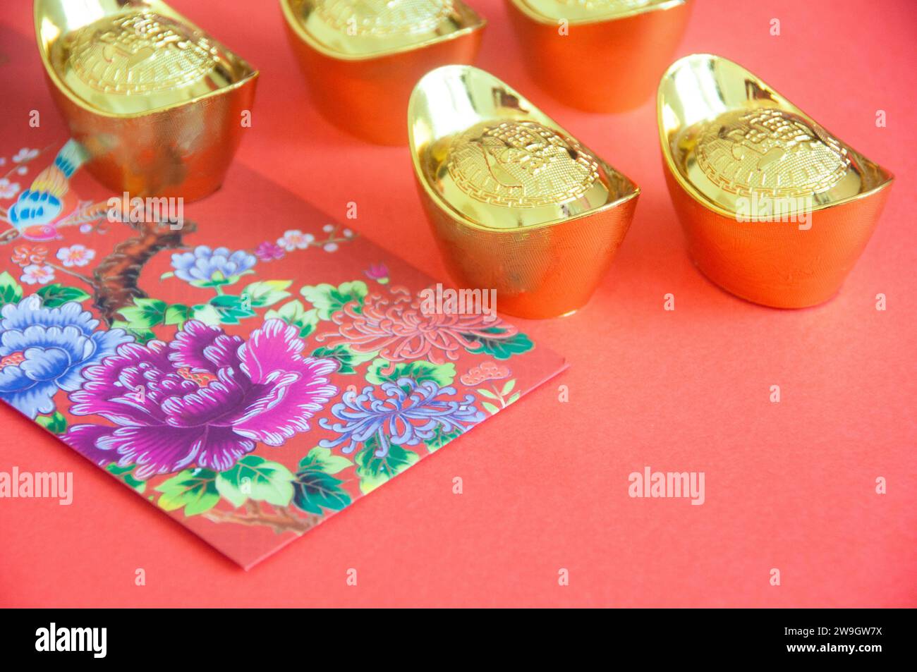 Chinese New Year decoration with colorful packets and golden ingots on