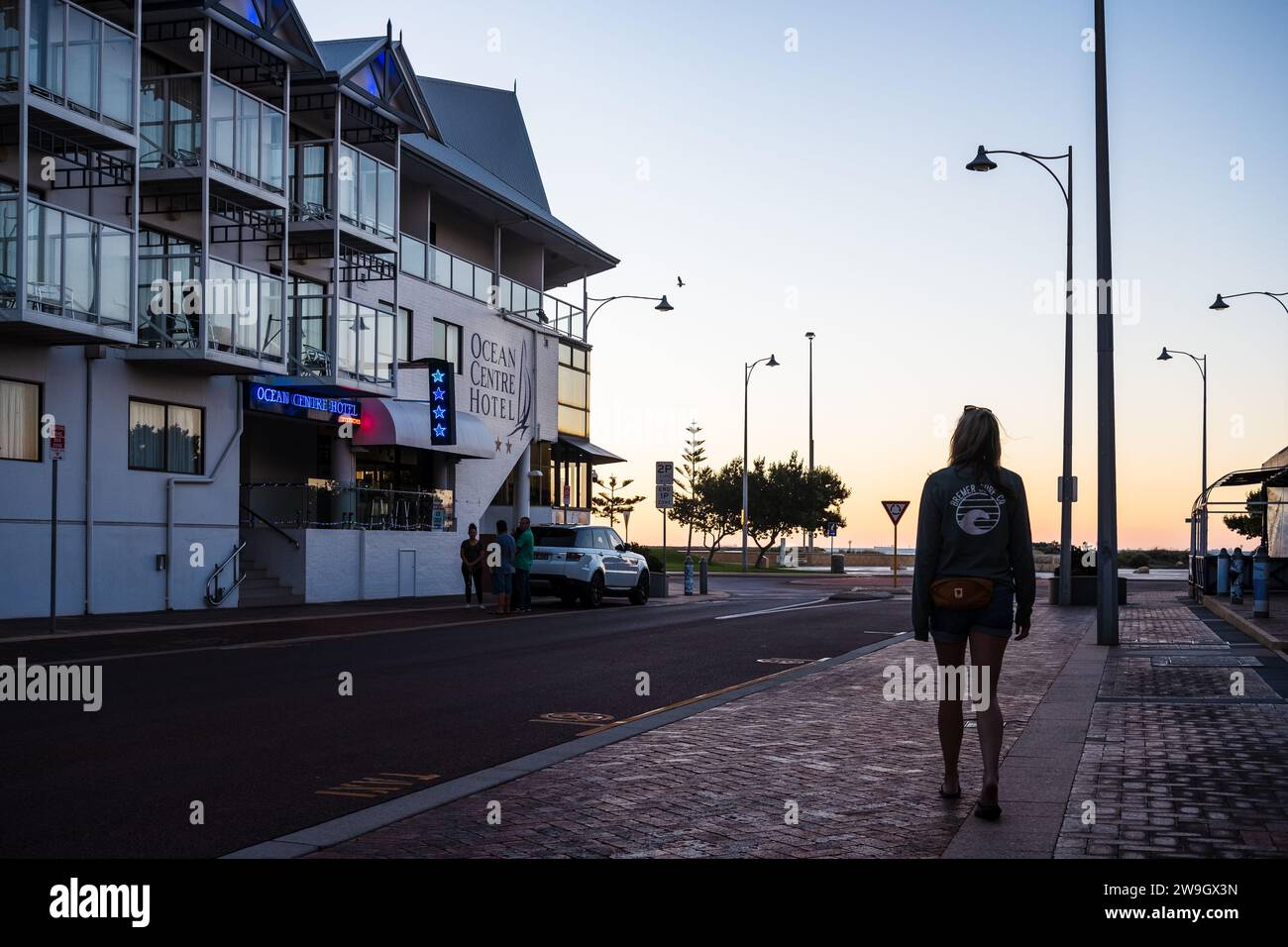 A woman walks towards the ocean foreshore in Geraldton, a regional city in Western Australia. Stock Photo