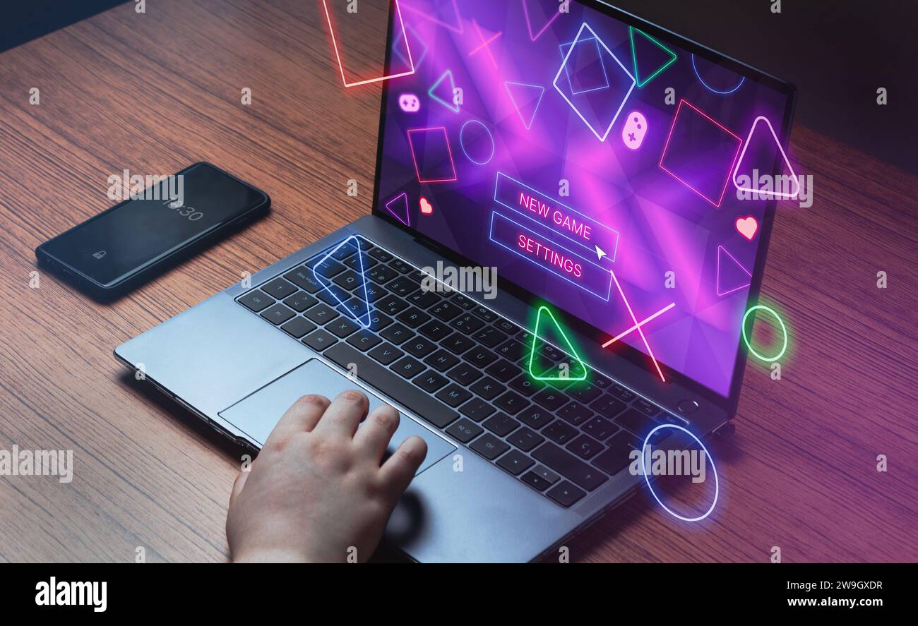 Woman use laptop to play games with neon icons VR interface. Playing online concept with empty space for text. Online entertainment and gamification. Stock Photo
