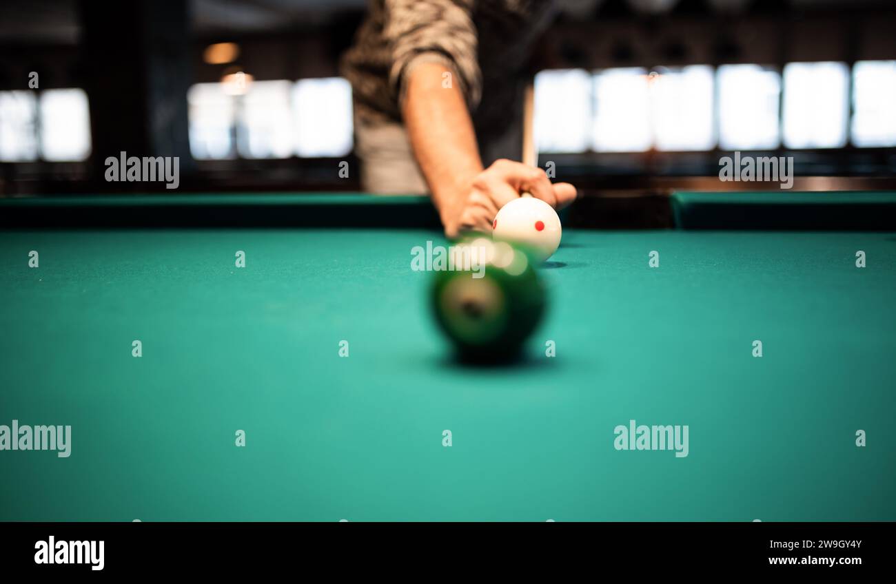 Young man playing snooker, aiming. for a good shot Stock Photo