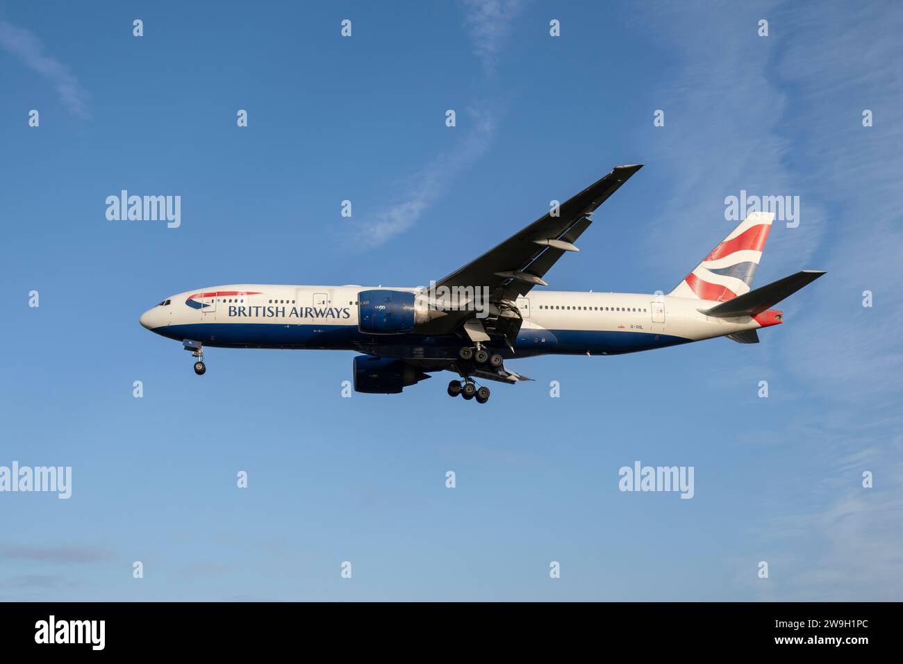 British Airways Boeing 777 Passenger Jet Airplane Registration G-VIIL on short finals for a landing on runway 27L at Heathrow Airport Stock Photo
