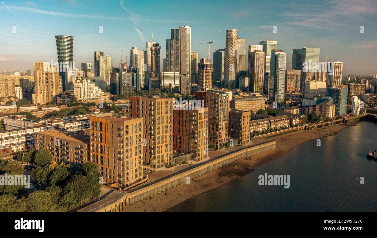 Aerial view of a city skyline from the banks of a river, with buildings ...