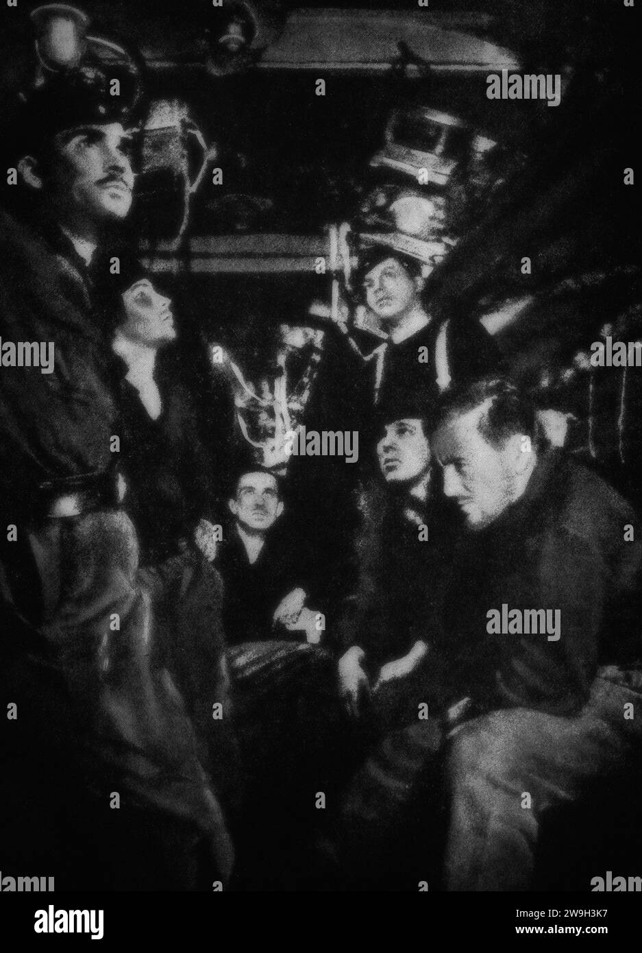The concern on faces of a German U-Boat crew as they wait depth charges dropped from a destroyer on Atlantic convoy escort duties in February 1943, during the Second World War. Stock Photo