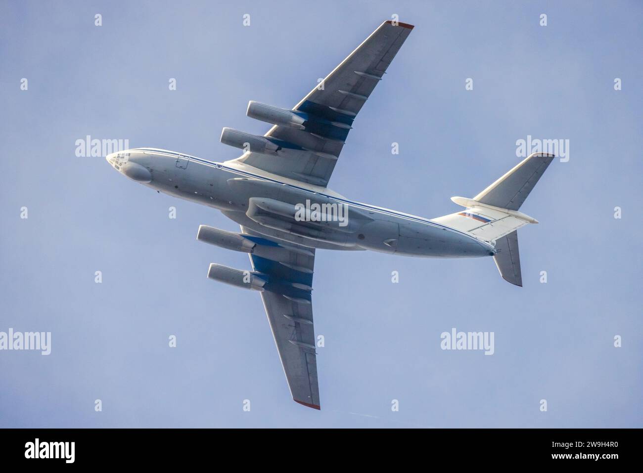 Soviet heavy multi-purpose, fixed-wing, four-engine turbofan strategic airlifter is in blue sky Stock Photo