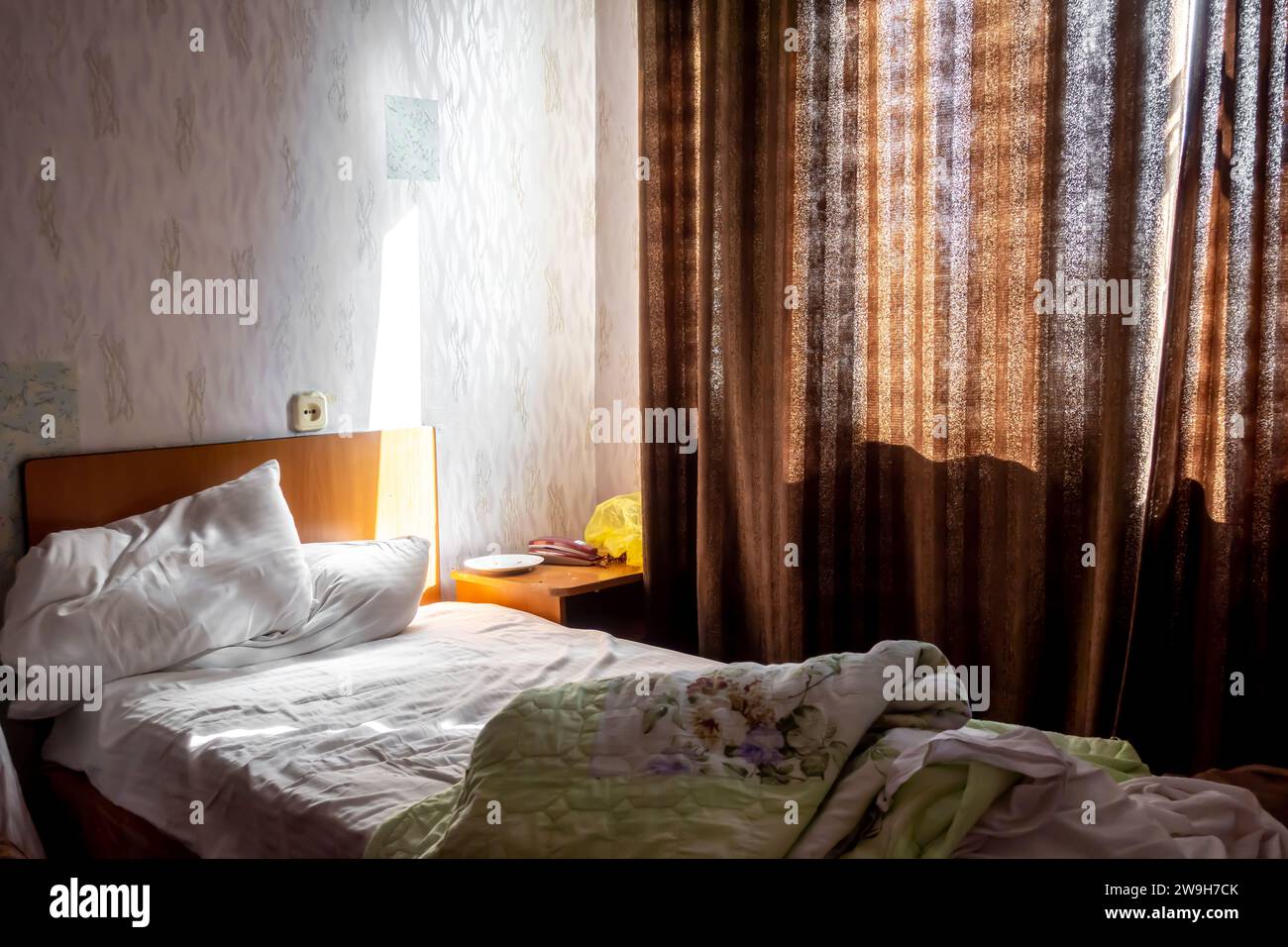 Standard room with unmade bed in Aktobe hotel - a 3-star cheap lodging in Aqtobe Kazakhstan Stock Photo