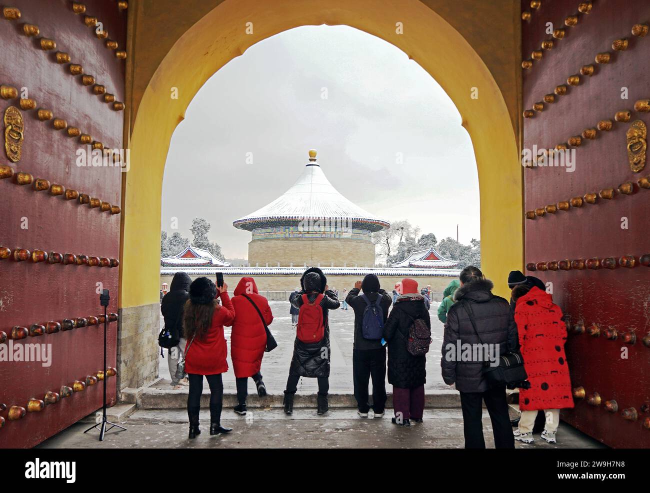 (231228) -- BEIJING, Dec. 28, 2023 (Xinhua) -- Visitors take photos at the Temple of Heaven in Beijing, capital of China, Dec. 11, 2023. First created in the Yuan Dynasty (1271-1368), the Beijing Central Axis, or Zhongzhouxian, stretches 7.8 kilometers between the Yongding Gate in the south of the city and the Drum Tower and Bell Tower in the north. Most of the major old-city buildings of Beijing sit along this axis. Gates, palaces, temples, squares and gardens of the old city are all linked up to the axis. As they witnessed the folk activities along the line from old days to new ones, they Stock Photo