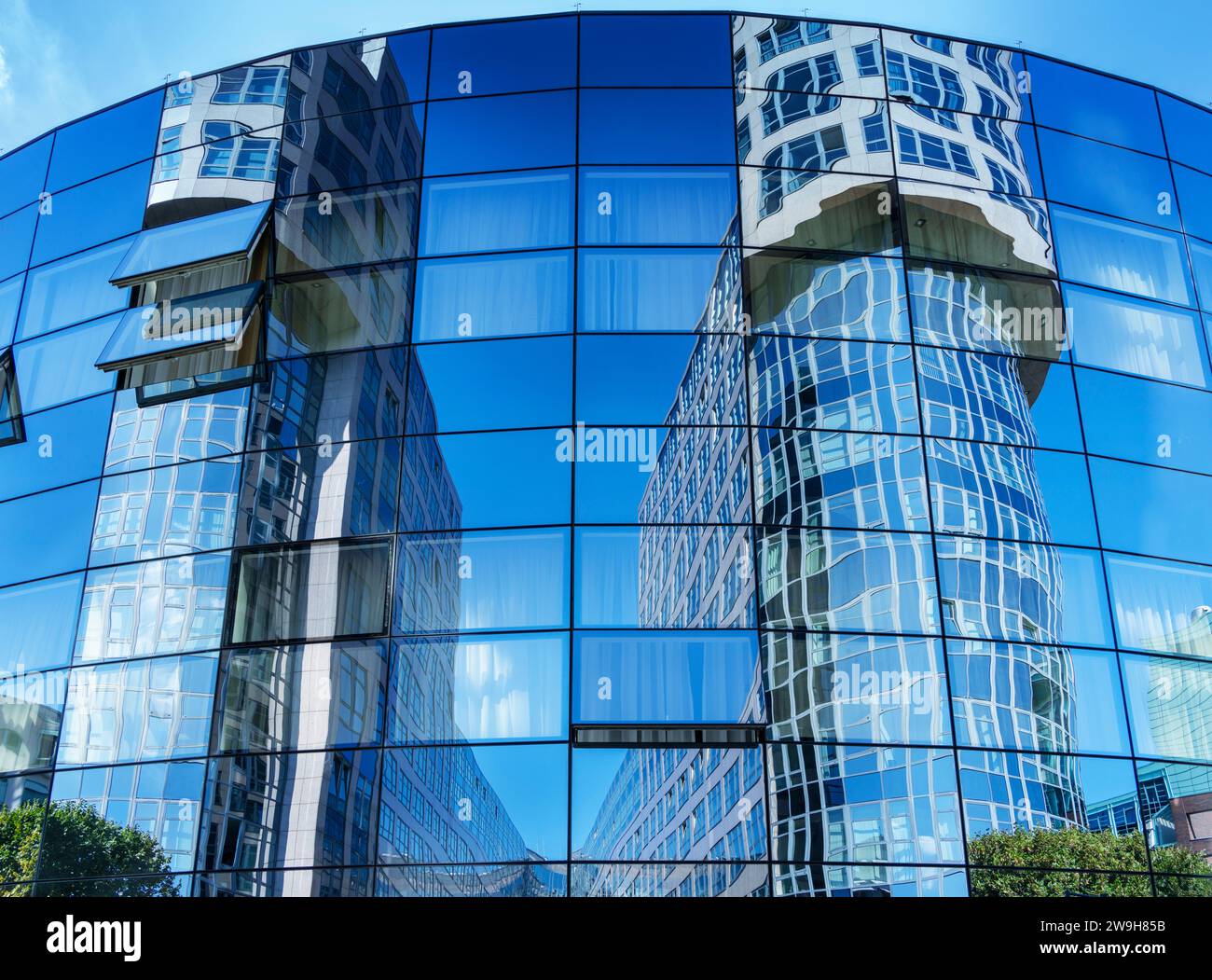 Office Towers Are Reflected In The Glass Facade Of The Abion Hotel, Spreebogen Alt-Moabit, Berlin, Germany Stock Photo