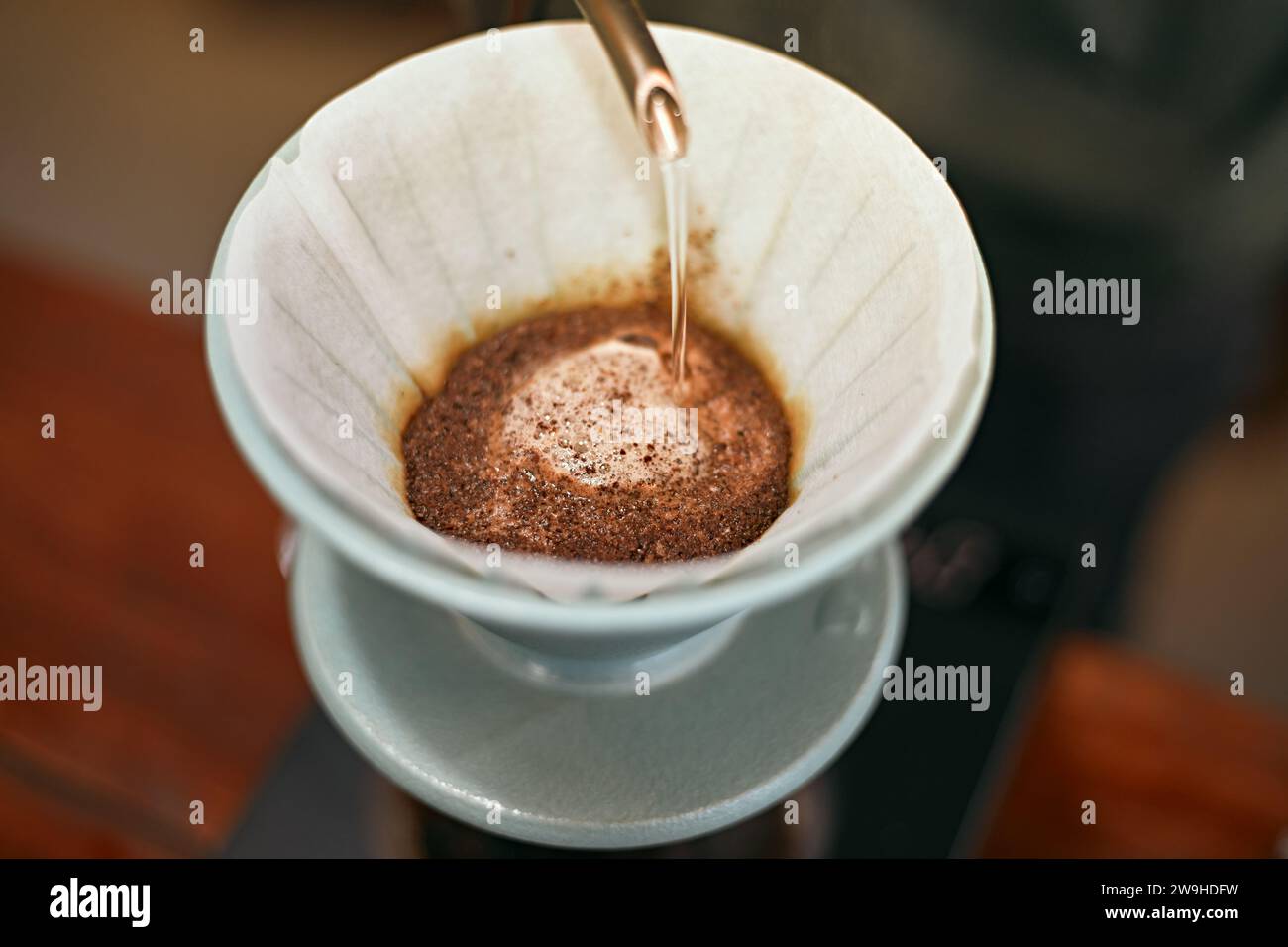 drip coffee, Barista making drip coffee by pouring spills hot water Stock Photo