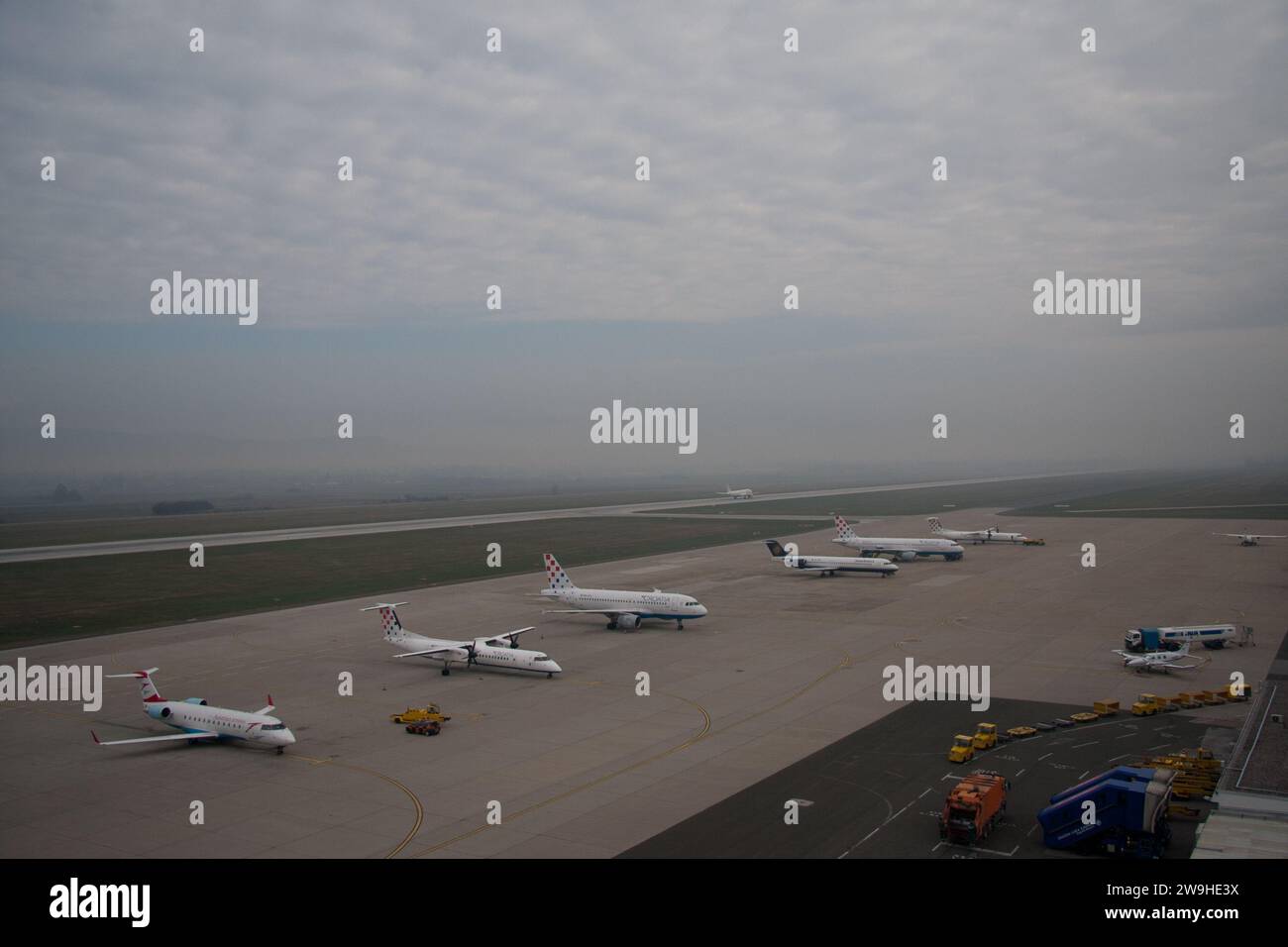 Airplanes on tarmac under sunset Stock Photo - Alamy