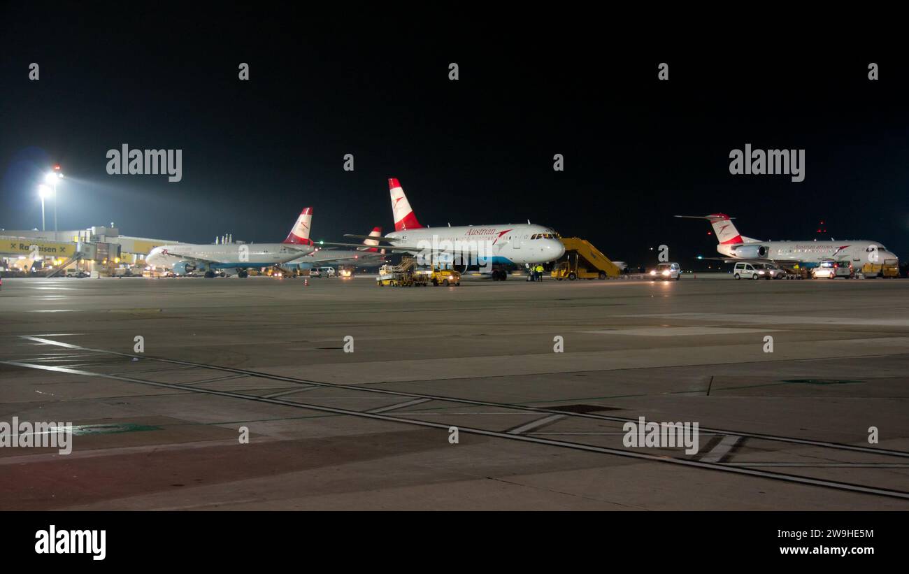 Airplanes on tarmac under sunset Stock Photo - Alamy