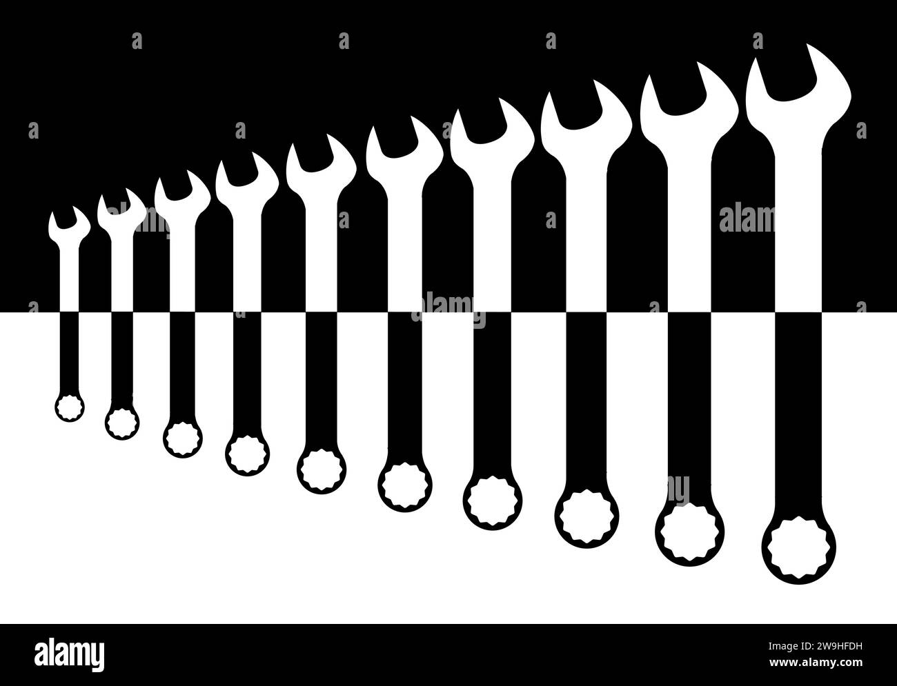 A collection of various sized mechanics spanners in black and white